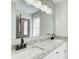 Modern bathroom featuring double sinks, granite countertop, and a large, well-lit mirror at 2270 Old Concord Se Dr, Covington, GA 30016