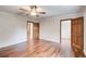 Bright bedroom featuring hardwood floors and multiple doors at 2270 Old Concord Se Dr, Covington, GA 30016