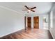 Spacious bedroom with hardwood floors, ceiling fan, and access to the ensuite bathroom at 2270 Old Concord Se Dr, Covington, GA 30016