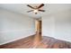 Neutral bedroom featuring wood floors, paneled walls, double closet, and ceiling fan at 2270 Old Concord Se Dr, Covington, GA 30016