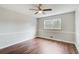 Comfortable bedroom featuring wood floors, paneled walls, and a ceiling fan at 2270 Old Concord Se Dr, Covington, GA 30016