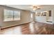 Bright living room featuring wood floors, neutral walls, a ceiling fan, and a large window for natural light at 2270 Old Concord Se Dr, Covington, GA 30016