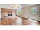 Inviting living room with brick fireplace, wood floors, and a window bringing in natural light at 2270 Old Concord Se Dr, Covington, GA 30016