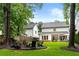Beautiful backyard with a fire pit, manicured lawn, patio, and view of the home's exterior at 281 Green Hill Rd, Atlanta, GA 30342