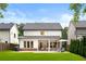 Exterior of home with a large backyard, covered patio, a grill, and manicured landscaping at 281 Green Hill Rd, Atlanta, GA 30342
