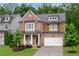 Charming brick home with a covered front porch, manicured landscaping, and a two-car garage at 281 Green Hill Rd, Atlanta, GA 30342