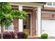 Detailed view of the front door, brick facade, and manicured landscaping around this home at 281 Green Hill Rd, Atlanta, GA 30342