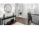 Elegant hallway with dark hardwood floors, a console table, and a view into the laundry room at 281 Green Hill Rd, Atlanta, GA 30342