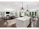 Open-concept living room with a fireplace and built-in shelving, flowing into the modern kitchen at 281 Green Hill Rd, Atlanta, GA 30342