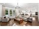 Open-concept living area with hardwood floors, neutral decor, and seamless connection to the kitchen at 281 Green Hill Rd, Atlanta, GA 30342