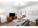 Bright living room showcasing hardwood floors, a gray sofa with ottoman, and contemporary decor at 281 Green Hill Rd, Atlanta, GA 30342