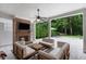 Covered patio with a brick fireplace, lounge area, and view of the backyard at 281 Green Hill Rd, Atlanta, GA 30342