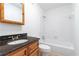 Bathroom featuring a vanity with granite countertop, tile flooring and a tub with white tiling at 1201 Old Hammond, Atlanta, GA 30350