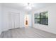 Bedroom featuring wood-look floors, closet with bi-fold doors and a window at 1201 Old Hammond, Atlanta, GA 30350