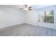 Bright bedroom with gray wood-look flooring, a ceiling fan and a window offering natural light at 1201 Old Hammond, Atlanta, GA 30350