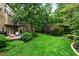 Expansive backyard with lush green lawn, mature trees, and a charming patio area for outdoor enjoyment at 2314 Tall Timbers Ln, Marietta, GA 30066