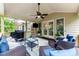Inviting covered patio with comfortable seating, ceiling fan, and serene wooded views at 2314 Tall Timbers Ln, Marietta, GA 30066