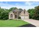 Charming two-story home with stone accents, a well-manicured lawn, and a two-car garage at 2314 Tall Timbers Ln, Marietta, GA 30066