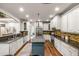 Spacious kitchen features stainless appliances, center island, granite counters, mosaic backsplash and hardwood floors at 2314 Tall Timbers Ln, Marietta, GA 30066