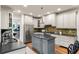 Well-lit kitchen featuring stainless appliances, center island, granite counters, mosaic backsplash, and hardwood floors at 2314 Tall Timbers Ln, Marietta, GA 30066