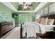Comfortable main bedroom featuring hardwood floors, tray ceilings, and stylish decor with a light, airy feel at 2314 Tall Timbers Ln, Marietta, GA 30066