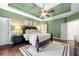 This bedroom boasts tray ceilings, hardwood floors, and ample natural light at 2314 Tall Timbers Ln, Marietta, GA 30066