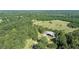 Aerial view showing home and surrounding property, including lush green grass at 2371 Leguin Mill Rd, Locust Grove, GA 30248