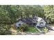 An aerial view of the light blue home on a lush lot surrounded by a dense, mature forest at 2371 Leguin Mill Rd, Locust Grove, GA 30248