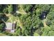 Aerial view of secluded property featuring mature trees and multiple buildings at 2371 Leguin Mill Rd, Locust Grove, GA 30248