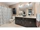 Double sink bathroom with dark wood cabinets and ample counter space at 2371 Leguin Mill Rd, Locust Grove, GA 30248