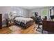 Bedroom with hardwood floors, window views and desk area with a gaming chair at 2371 Leguin Mill Rd, Locust Grove, GA 30248