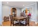 Cozy dining area featuring hardwood floors, a bar pass-through, and a decorative display cabinet at 2371 Leguin Mill Rd, Locust Grove, GA 30248