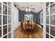 Dining room with hardwood floors, China cabinet, and view through french doors at 2371 Leguin Mill Rd, Locust Grove, GA 30248