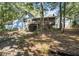 View of the side of a two-story blue house with wood deck and drive under garage at 2371 Leguin Mill Rd, Locust Grove, GA 30248