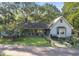Charming light blue home nestled on a lush lot with mature trees and welcoming front porch at 2371 Leguin Mill Rd, Locust Grove, GA 30248