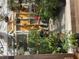 Interior of greenhouse shows plants, pots, gravel floor and yellow background at 2371 Leguin Mill Rd, Locust Grove, GA 30248