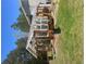 Exterior view of a wooden framed greenhouse with glass windows and roof at 2371 Leguin Mill Rd, Locust Grove, GA 30248