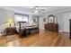 Main bedroom with hardwood floors, a ceiling fan, and elegant furniture at 2371 Leguin Mill Rd, Locust Grove, GA 30248
