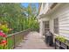 Back deck with outdoor seating and a grill overlooking a lush backyard at 4865 Chesterfield Ct, Suwanee, GA 30024