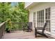 Back deck with outdoor seating, adjacent to lush greenery at 4865 Chesterfield Ct, Suwanee, GA 30024