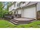 View of the back of the house featuring a deck, white siding, and green lawn at 4865 Chesterfield Ct, Suwanee, GA 30024