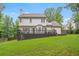 Backyard with a large grassy lawn and a view of the house featuring a deck at 4865 Chesterfield Ct, Suwanee, GA 30024