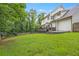 Large backyard with green grass, a wooden fence, and the back of the house at 4865 Chesterfield Ct, Suwanee, GA 30024