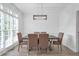Dining room with large windows providing plenty of natural light and modern lighting at 4865 Chesterfield Ct, Suwanee, GA 30024