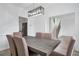 Elegant dining room features modern lighting and is adjacent to the kitchen area at 4865 Chesterfield Ct, Suwanee, GA 30024
