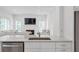 Bright kitchen with stainless steel appliances connected to the spacious living room at 4865 Chesterfield Ct, Suwanee, GA 30024