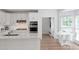 Bright white kitchen with modern appliances, granite countertops, and a breakfast nook at 4865 Chesterfield Ct, Suwanee, GA 30024