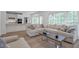 Open-concept living area with hardwood floors, access to the kitchen, and natural lighting at 4865 Chesterfield Ct, Suwanee, GA 30024