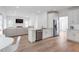 Open-concept living space with stainless steel appliances and a marble countertop island at 4865 Chesterfield Ct, Suwanee, GA 30024