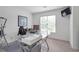 Bright office space with a glass desk, shelving, and large window with natural light at 4865 Chesterfield Ct, Suwanee, GA 30024